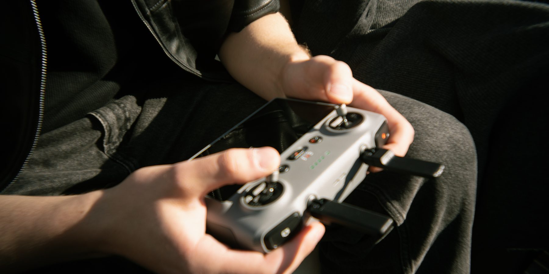 Two hands working a gimbal controller on an Artzmen Creative shoot