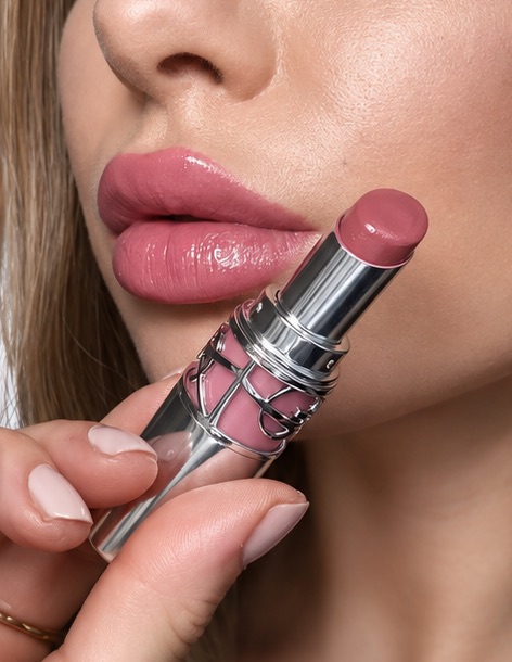 A close crop of lips beside the lipstick bullet