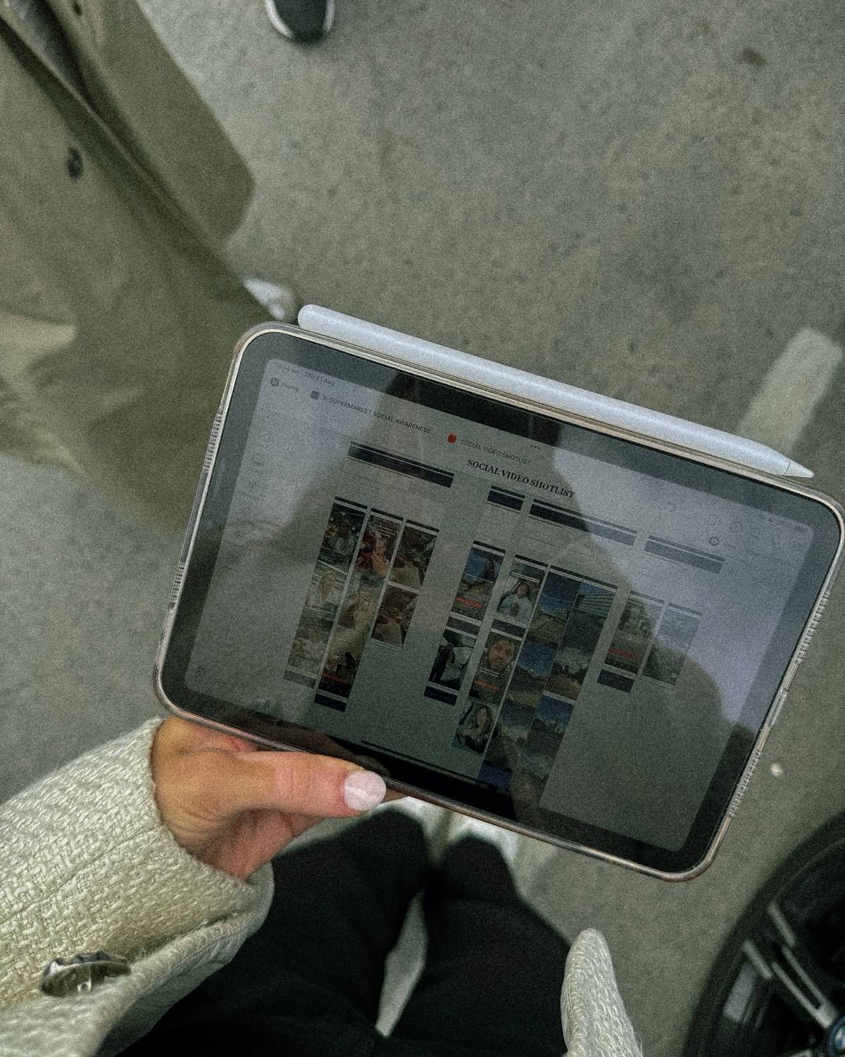 A social video shot list open on an iPad, held over a supermarket floor
