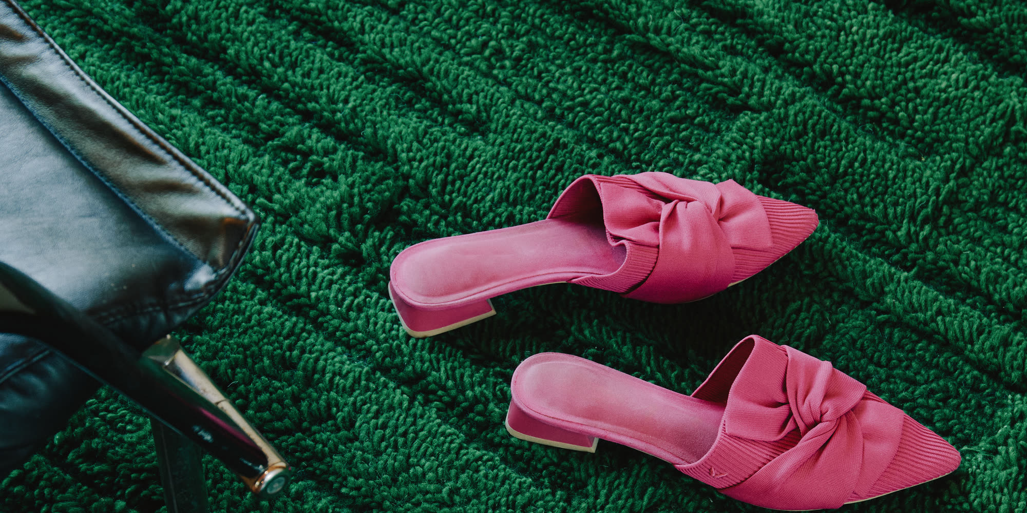 Pink mules on the emerald Tobevi Forest Green wool rug by Ervin Latimer